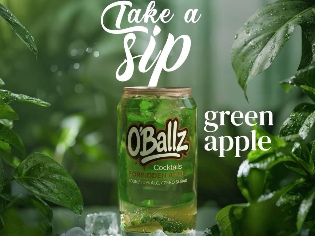 A can of O'Ballz Forbidden Apple cocktail on ice among leaves, with the brand's 'Take a sip, green apple' lettering
