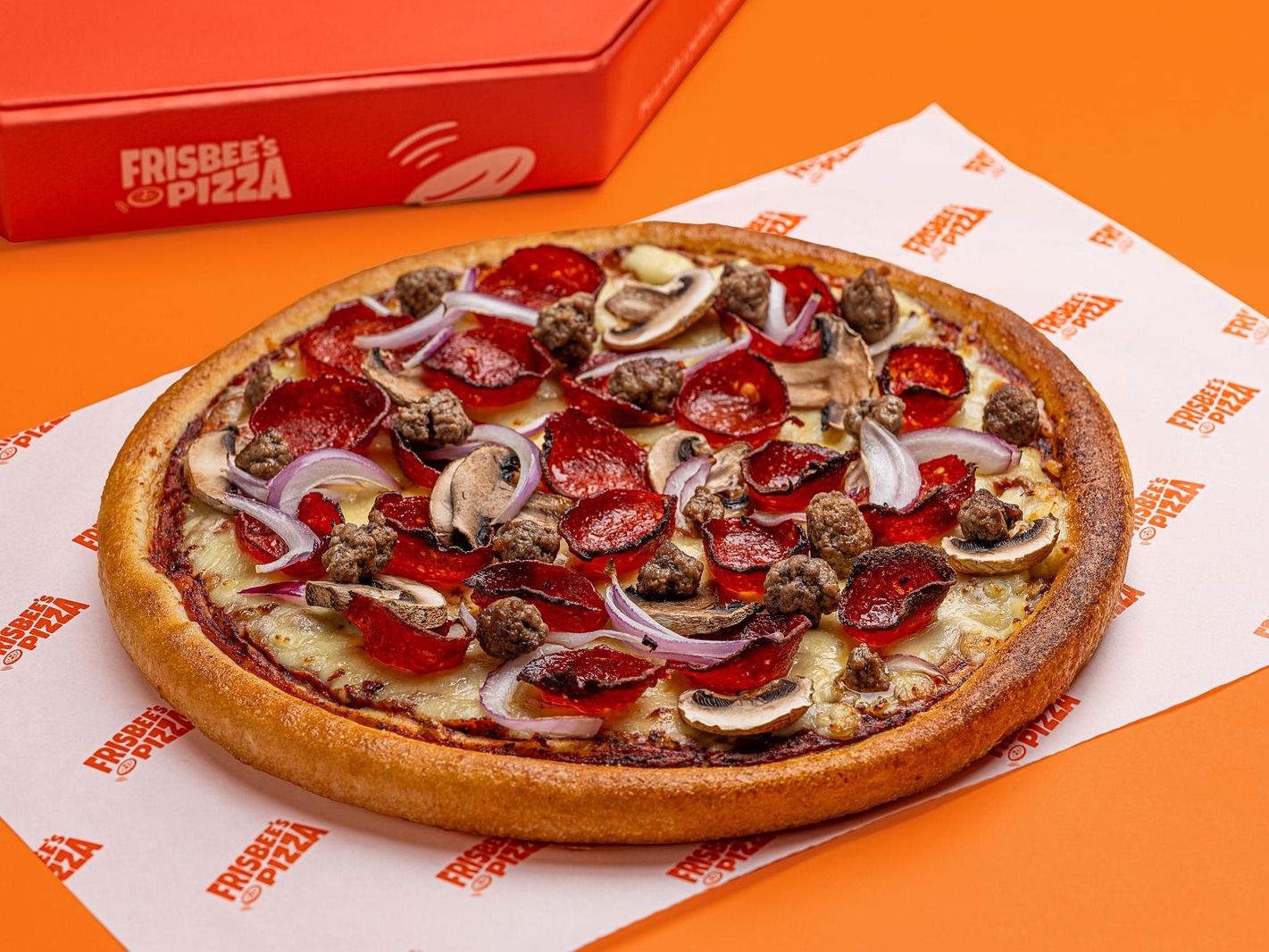 Frisbee's All Star pan pizza with pepperoni, sausage, onion and mushroom, on branded paper